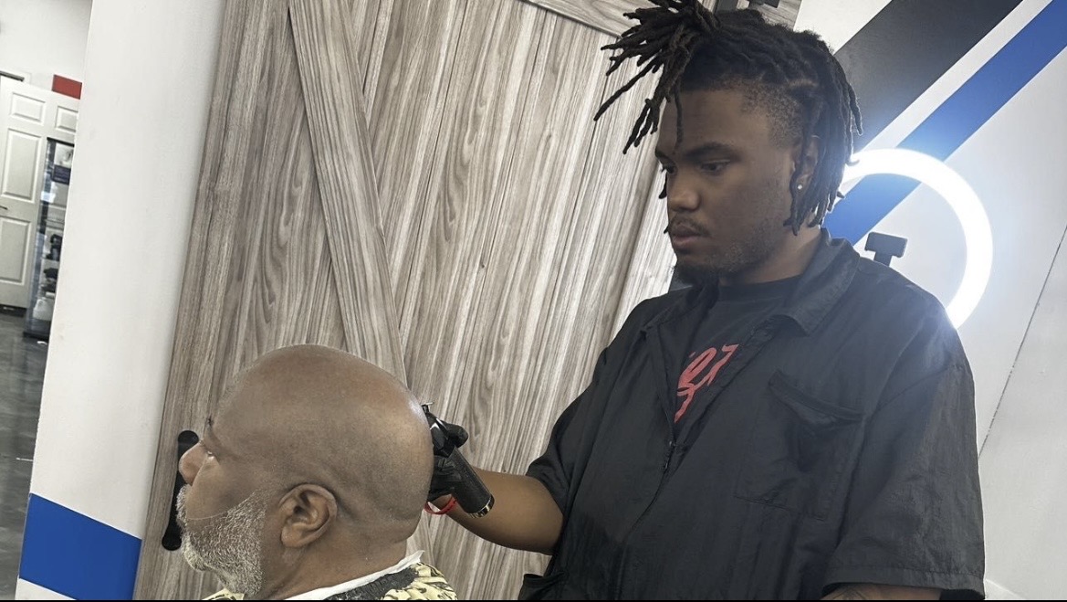 Josh of Cuts By HBK Josh fading a client's hair in his Locust Grove, Georgia barbershop